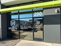 Front entrance of a building with 'Motiv' branding and glass doors decalwolf decal wolf arizona minnesota