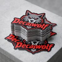 A stack of die-cut decals featuring a gray wolf head with red eyes and the word "Decalwolf" in red across the front decal wolf arizona